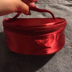 A small red cosmetic bag